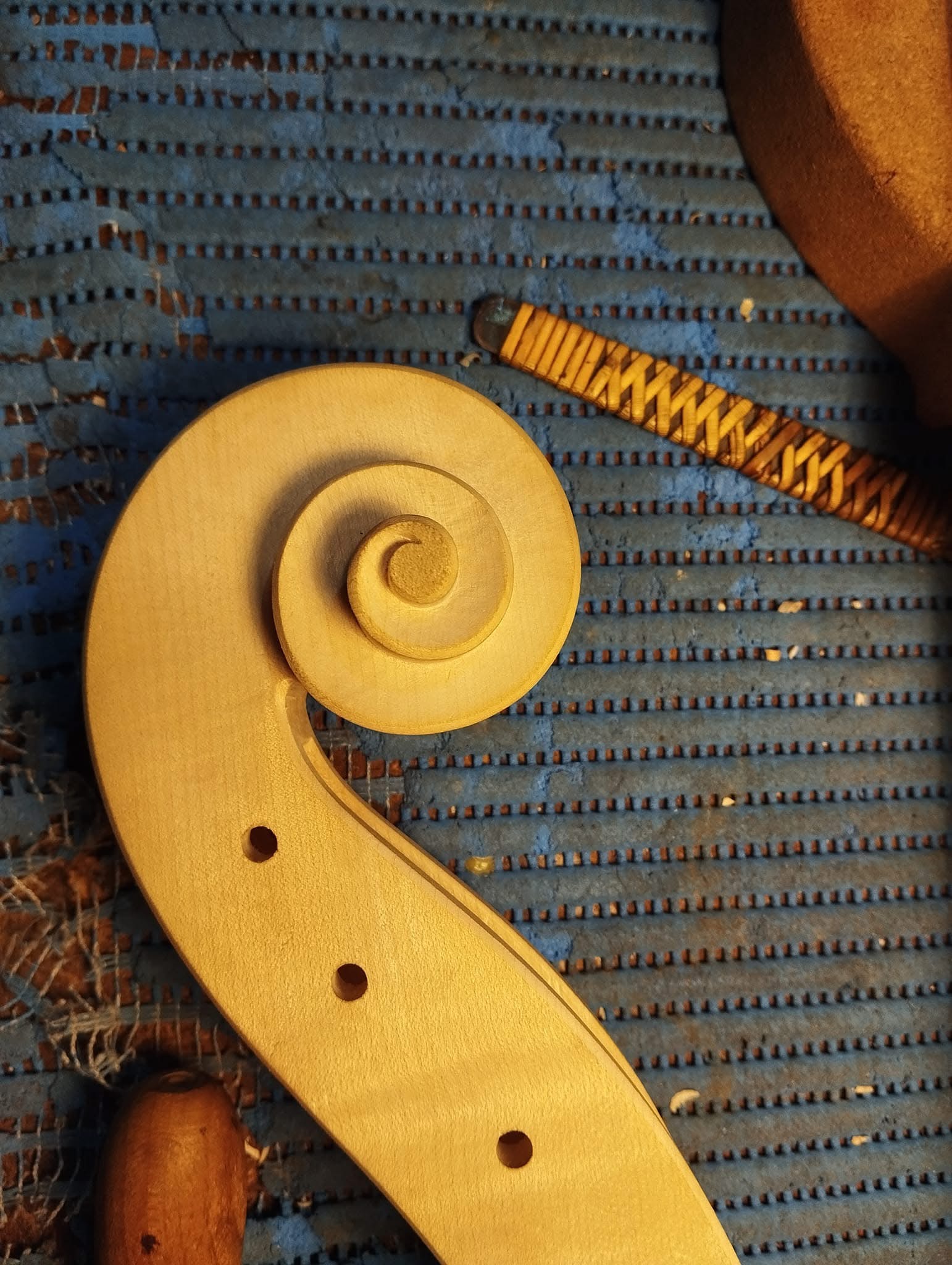 Hand-carved scroll during the making of a Fabio Nicotra instrument